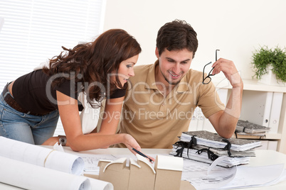 Young man and woman working at architect office