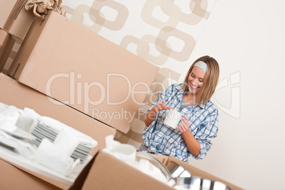 Moving house: Happy woman with box