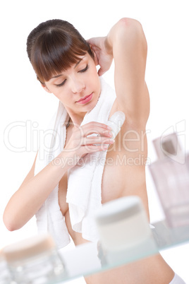 Body care: Attractive woman applying deodorant