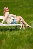 Spring and summer - Young woman relaxing in meadow
