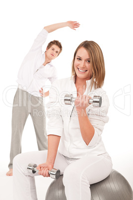 Fitness - Young couple training with weights and ball