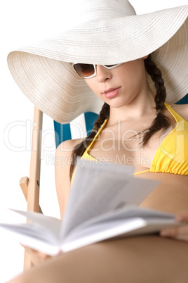 Beach - Young woman in bikini sunbath with book