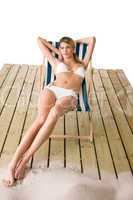 Beach - Woman in bikini sunbathing on deck chair
