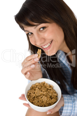 Smiling woman eat whole wheat cereal in pajamas