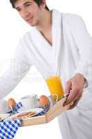 Breakfast - young man holding tray with breakfast