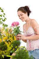 Gardening - smiling woman holding flower pot