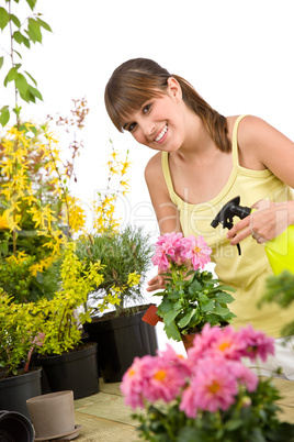 Gardening - smiling woman with flower and sprinkler
