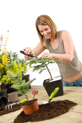 Gardening - woman trimming bonsai tree