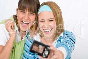 Two young cheerful woman taking picture