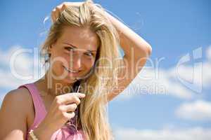 Blond woman hold sunglasses enjoy sunny day