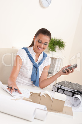 Female architect with phone at the office