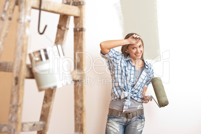 Home improvement: Blond woman painting wall