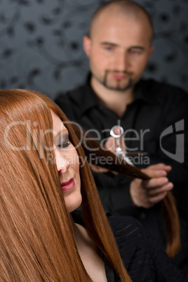 Professional hairdresser with fashion model at luxury salon