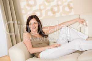Smiling woman relax on sofa in lounge