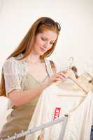 Fashion shopping - red hair woman choose sale clothes