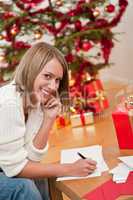 Attractive blond woman writing Christmas cards