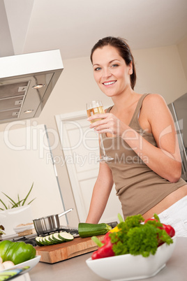 Smiling young woman cooking in the kitchen