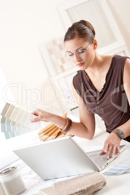 Smiling female designer with color swatch