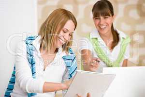 Student at home - two happy woman with laptop