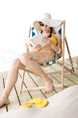 Beach - Young woman in bikini with book sunbathing