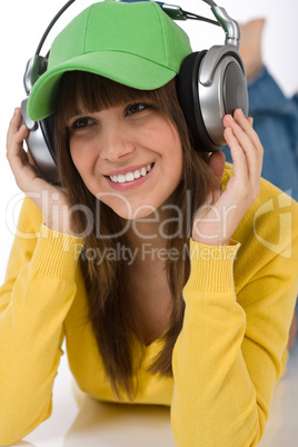 Happy female teenager enjoy music with headphones