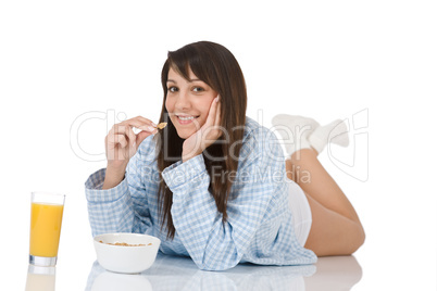 Smiling woman eat cereal for breakfast