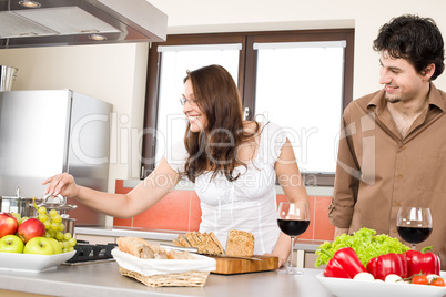 Happy couple cook together in modern kitchen