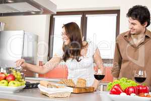 Happy couple cook together in modern kitchen