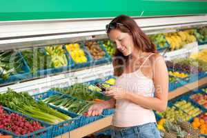 Grocery store shopping - Woman holding mobile phone