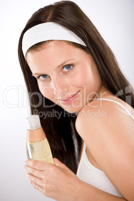 Body care - woman holding shampoo