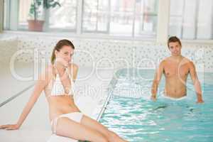 Swimming pool - young sportive couple relax