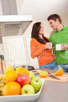 Happy couple drinking coffee in the kitchen