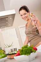 Smiling young woman cooking in the kitchen