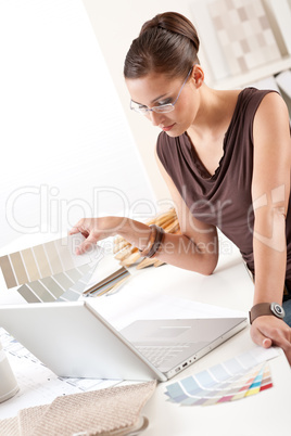 Smiling female designer with color swatch