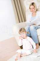 Mother and child - on the phone in living room