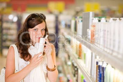 Shopping cosmetics - woman smelling shampoo