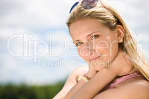 Portrait of blond woman with summer sky