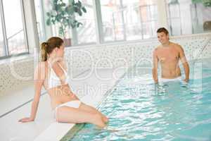 Swimming pool - young sportive couple relax