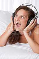 Young woman with headphones singing