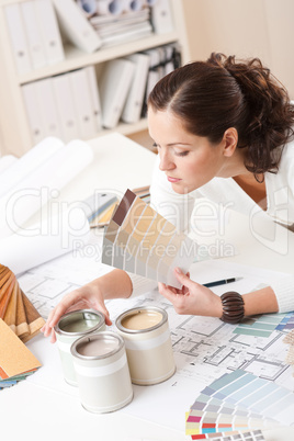 Young female interior designer at office with paint