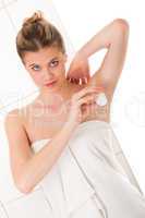 Body care series - Blond woman applying deodorant