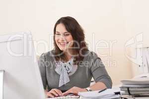 Young business woman working with computer at office