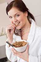 Happy woman holding bowl with cereals for breakfast