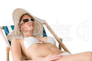 Beach - woman in bikini with hat sunbathing