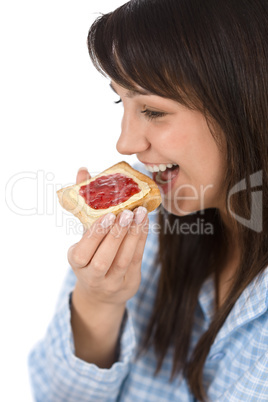 Smiling woman eat healthy toast for breakfast in pajamas