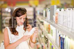 Shopping cosmetics - woman holding shampoo