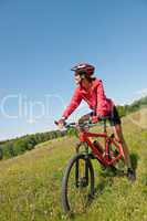 Young woman with mountain bike in spring nature