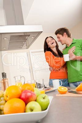 Happy couple drinking coffee in the kitchen