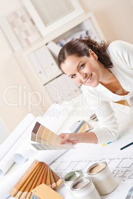 Young female interior designer at office with paint