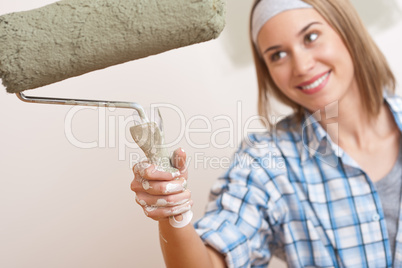 Home improvement: Young woman with paint roller